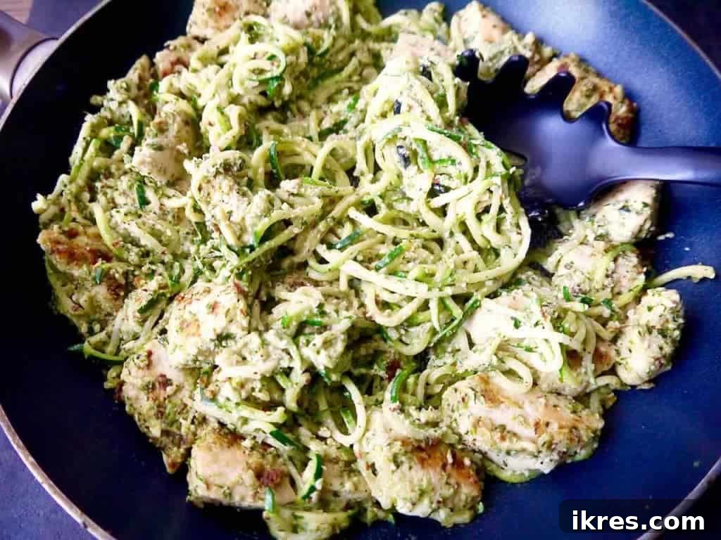 Vibrant Paleo Chicken and Zoodles with Green Pepper Almond Pesto 4 Close-up of a serving of Paleo Green Pepper and Almond Pesto Zoodles & Chicken, featuring vibrant green pesto, tender chicken, and spiralized zucchini noodles.