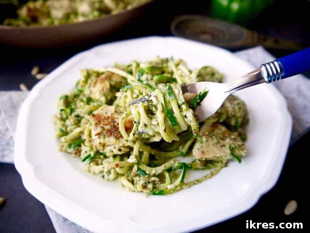 Vibrant Paleo Chicken and Zoodles with Green Pepper Almond Pesto 6 A beautifully plated dish of Paleo Green Pepper and Almond Pesto Zoodles & Chicken, garnished with fresh basil and pine nuts, ready to be enjoyed.