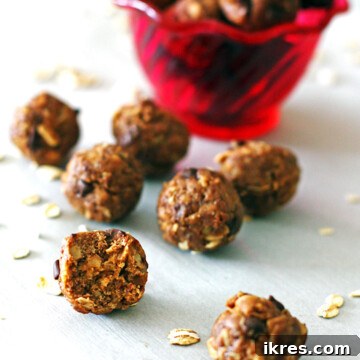 Peanut Butter Power Bites 7 Peanut butter energy balls in front of a red bowl with a bite taken out of one of them.