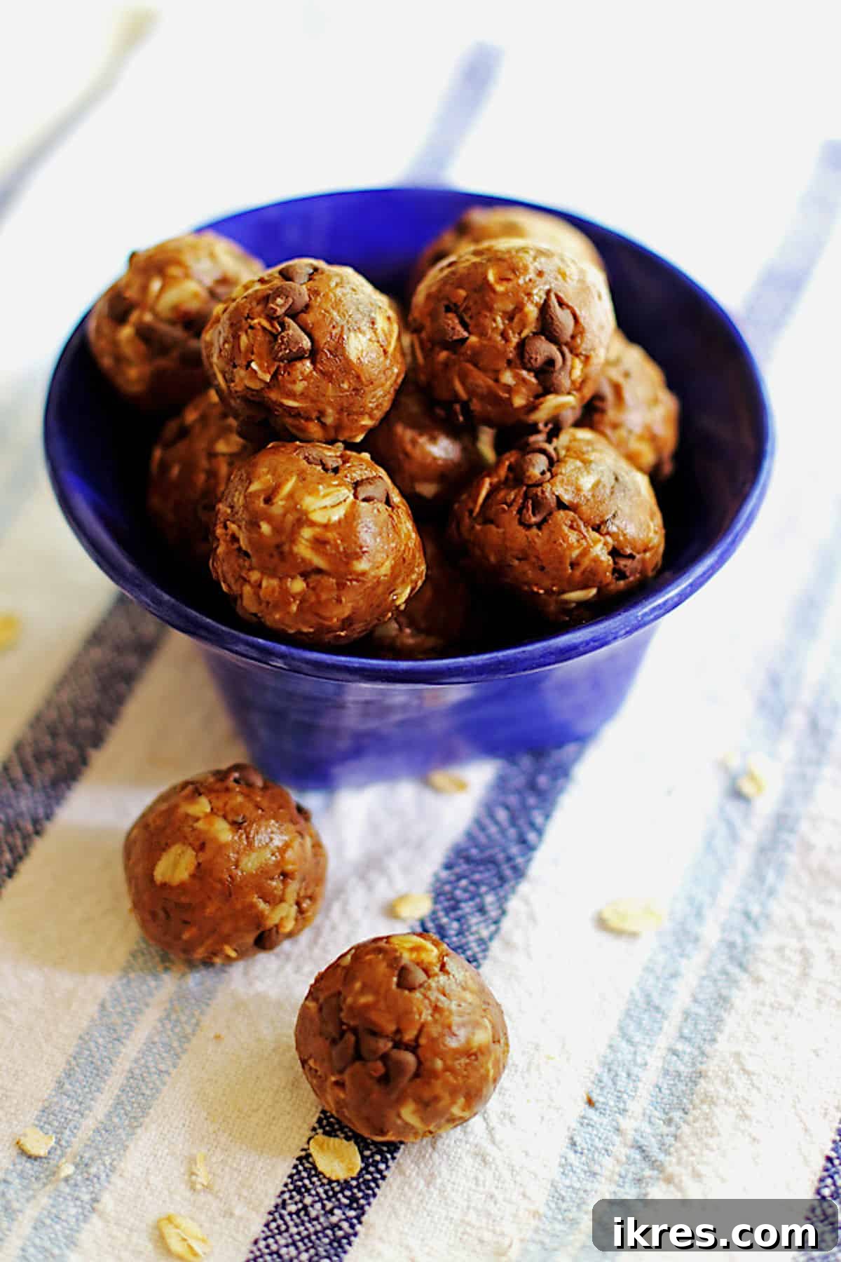 Peanut Butter Power Bites 6 A vibrant blue bowl filled with delicious no-bake oatmeal energy balls, highlighting their healthy and appealing texture.