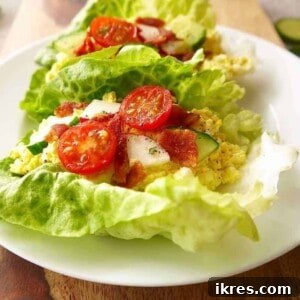 Egg Salad Lettuce Wraps with radish, tomatoes and cucumber on top.