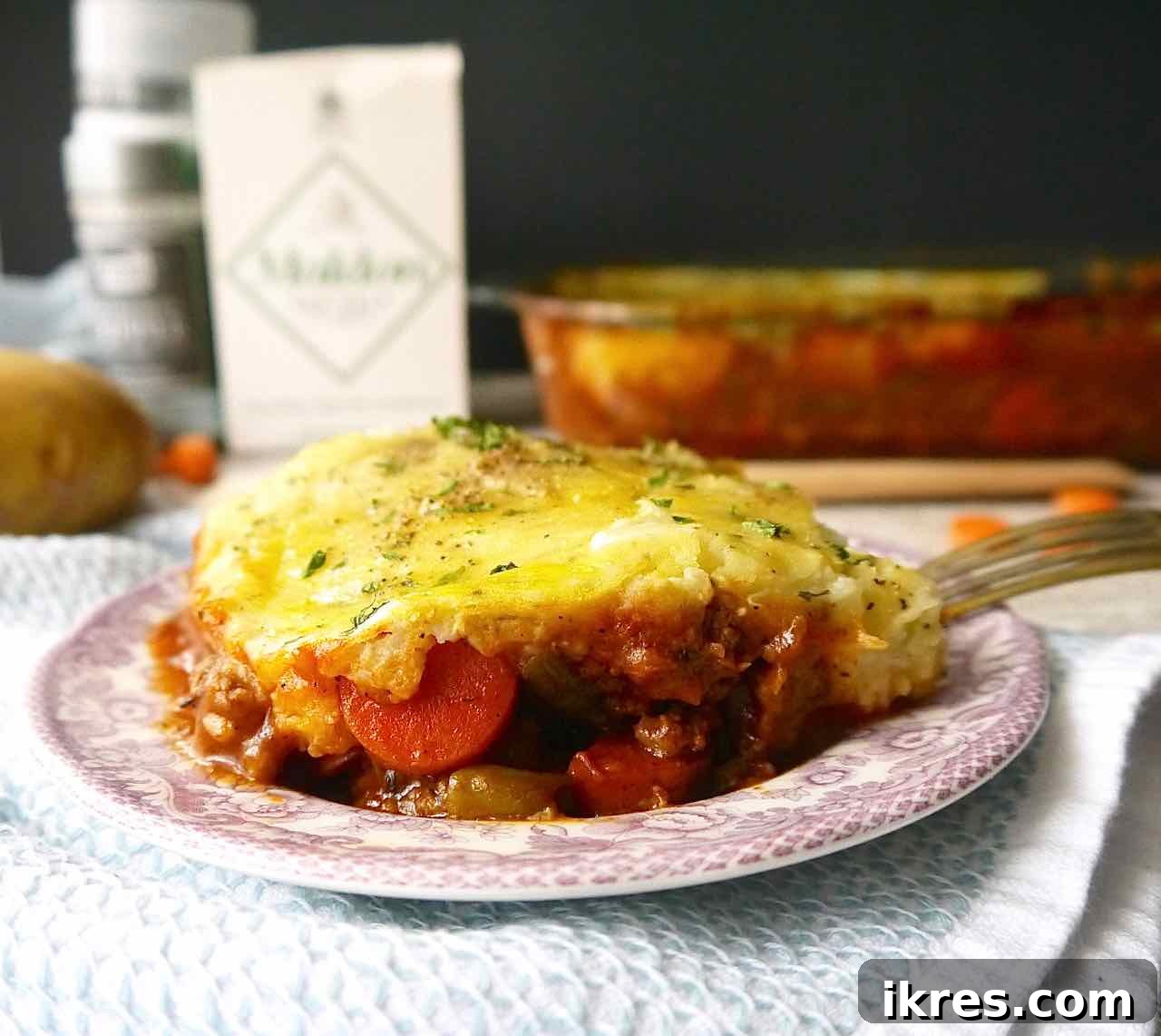 A serving of Paleo Shepherd's Pie plated beautifully, showcasing the golden-brown topping and rich filling.