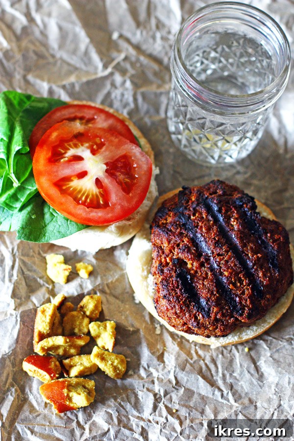 A vibrant selection of fresh ingredients for BBQ Ranch Burgers laid out, including ground beef, barbecue sauce, ranch dressing, bread crumbs, spices, and a red onion.
