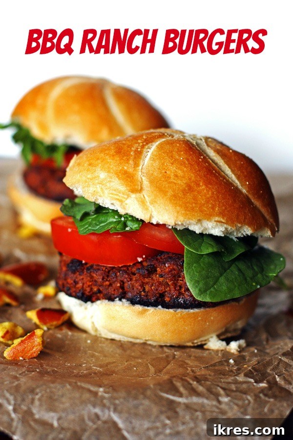 A plate featuring two delicious BBQ Ranch Hamburgers, each generously topped with fresh ingredients and a drizzle of sauce, ready to be enjoyed.