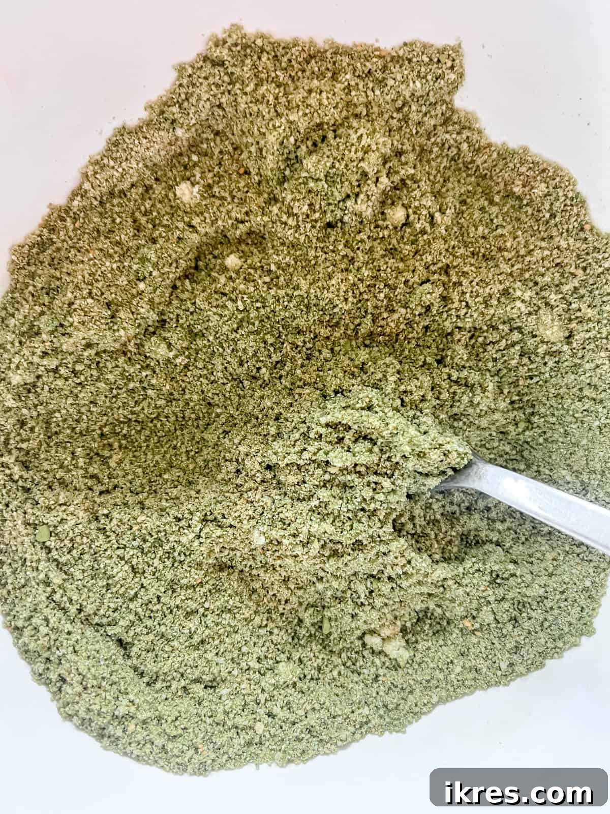 Almond Flour Matcha Brownies: A Paleo, Gluten-Free & Dairy-Free Delight 5 Dry ingredients for matcha brownies mixed together in a bowl, showing the green matcha powder evenly distributed.