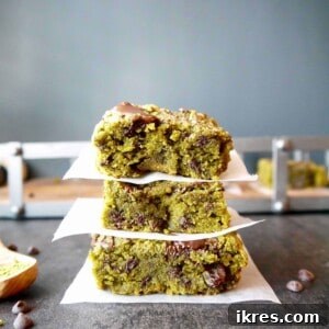 Almond Flour Matcha Brownies: A Paleo, Gluten-Free & Dairy-Free Delight 10 Paleo Matcha Blondies with Chocolate Chips and Raisins - A top-down view of a plate of vibrant green matcha blondies, garnished with chocolate chips and raisins.