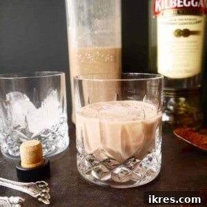 Homemade Dairy-Free Irish Cream Liqueur Recipe in a glass with ice.