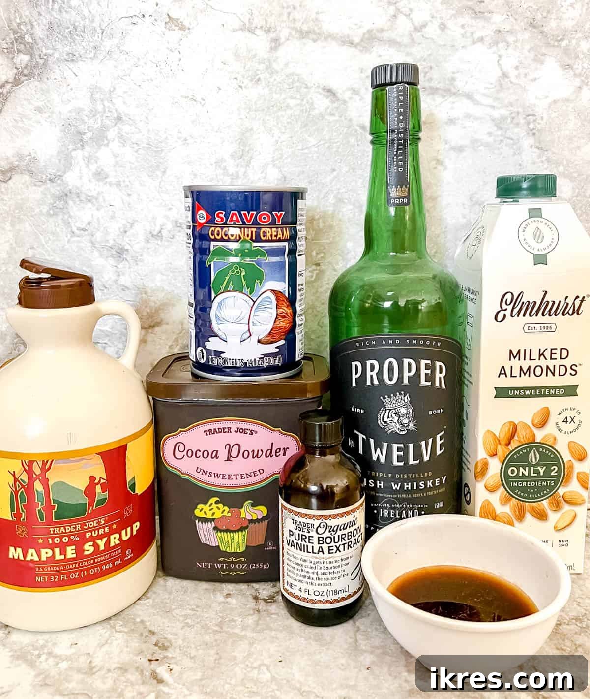 Dairy Free Irish Cream Liqueur From Scratch 4 Ingredients needed to make this healthy baileys recipe, laid out on a surface.