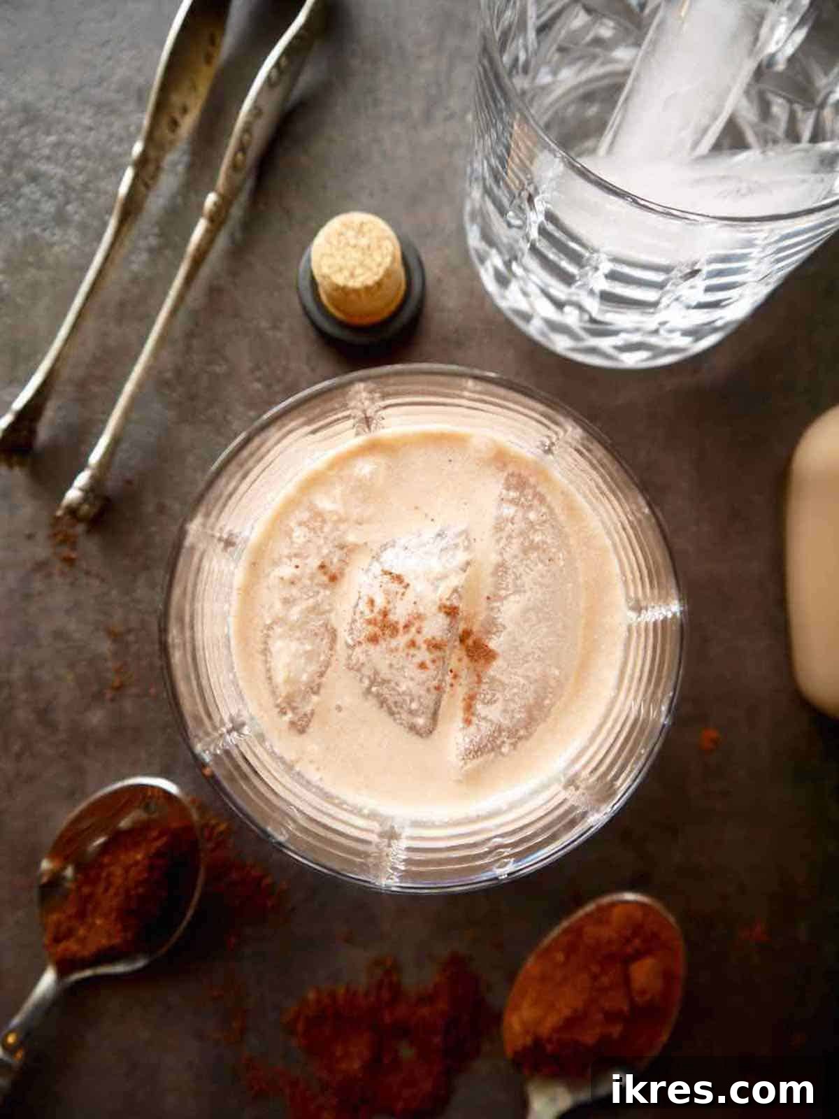 Dairy Free Irish Cream Liqueur From Scratch 8 A glass of Irish cream liqueur, aerial view, on a rustic surface.