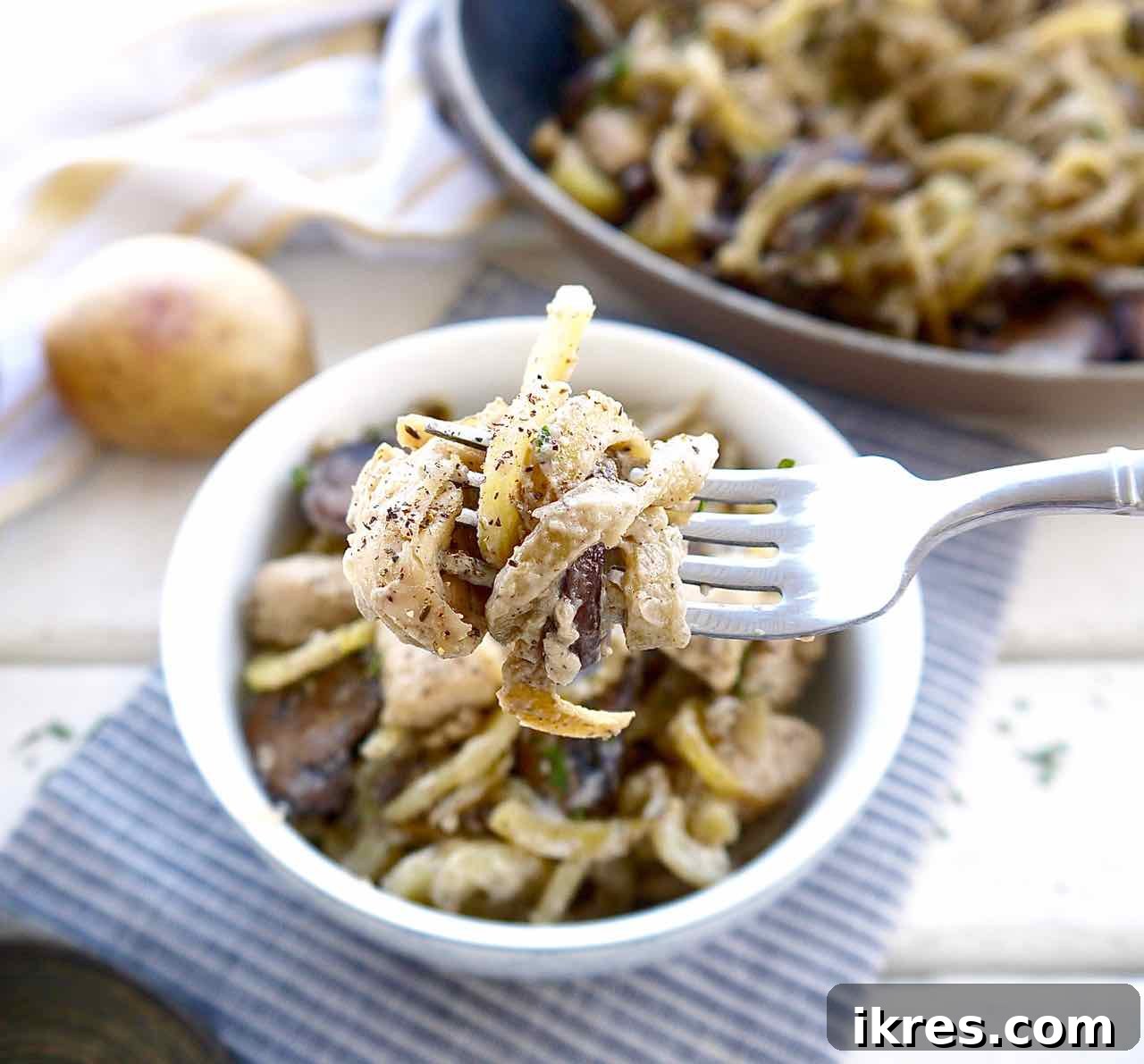 Another view of the hearty Whole30 casserole with mushrooms, chicken, and spiralized potatoes, garnished and ready.
