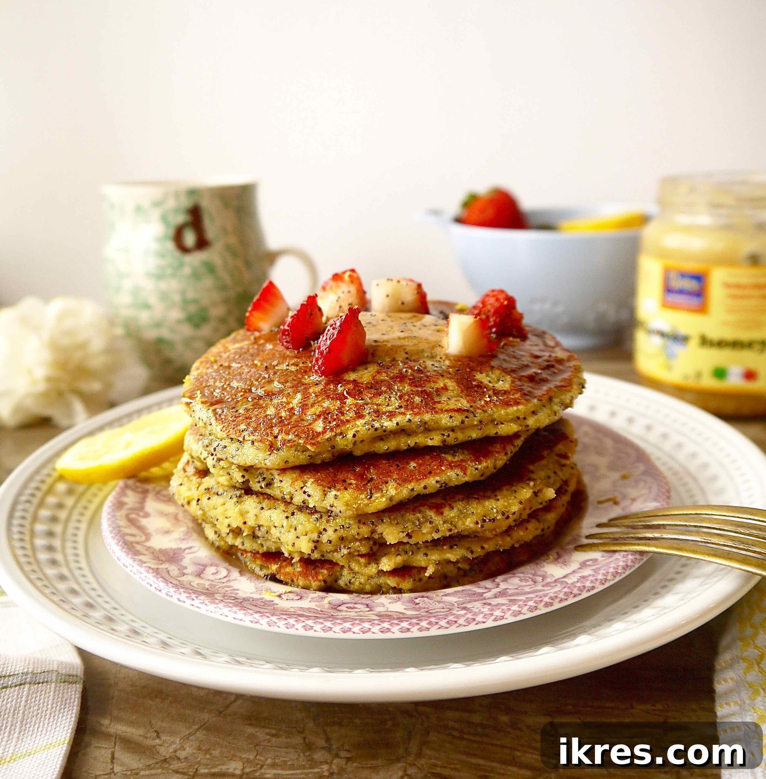 Paleo Zesty Lemon Poppy Seed Pancakes 3 A stack of golden gluten-free lemon poppyseed pancakes, ready to be topped and enjoyed.