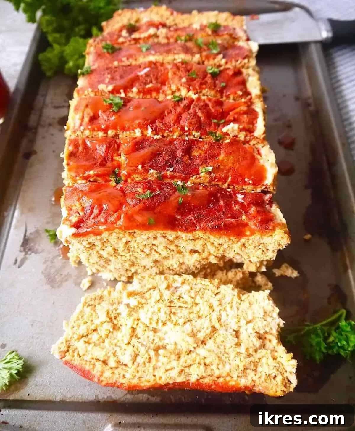 Spicy Buffalo Turkey Meatloaf Paleo Whole30 and Gluten Free 3 Paleo-friendly turkey meatloaf generously coated with a spicy hot sauce seasoning, presented beautifully on a pan.