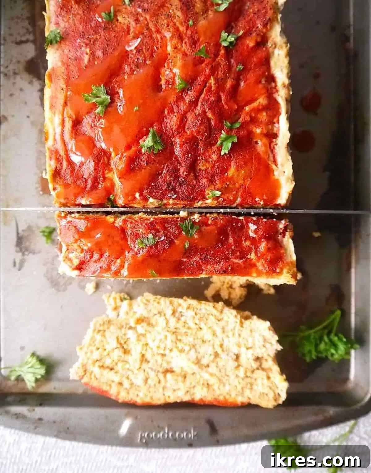Spicy Buffalo Turkey Meatloaf Paleo Whole30 and Gluten Free 4 A delicious hot sauce buffalo gluten-free turkey meatloaf resting on a pan, showcasing its rich, golden-brown crust.