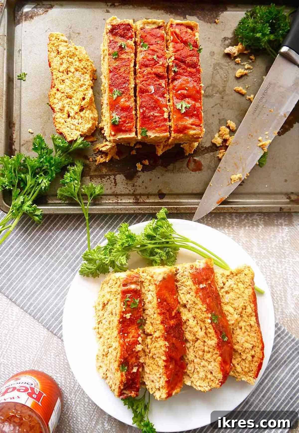 Spicy Buffalo Turkey Meatloaf Paleo Whole30 and Gluten Free 5 Succulent slices of buffalo meatloaf, perfectly cooked and ready to be served, arranged on a pan.