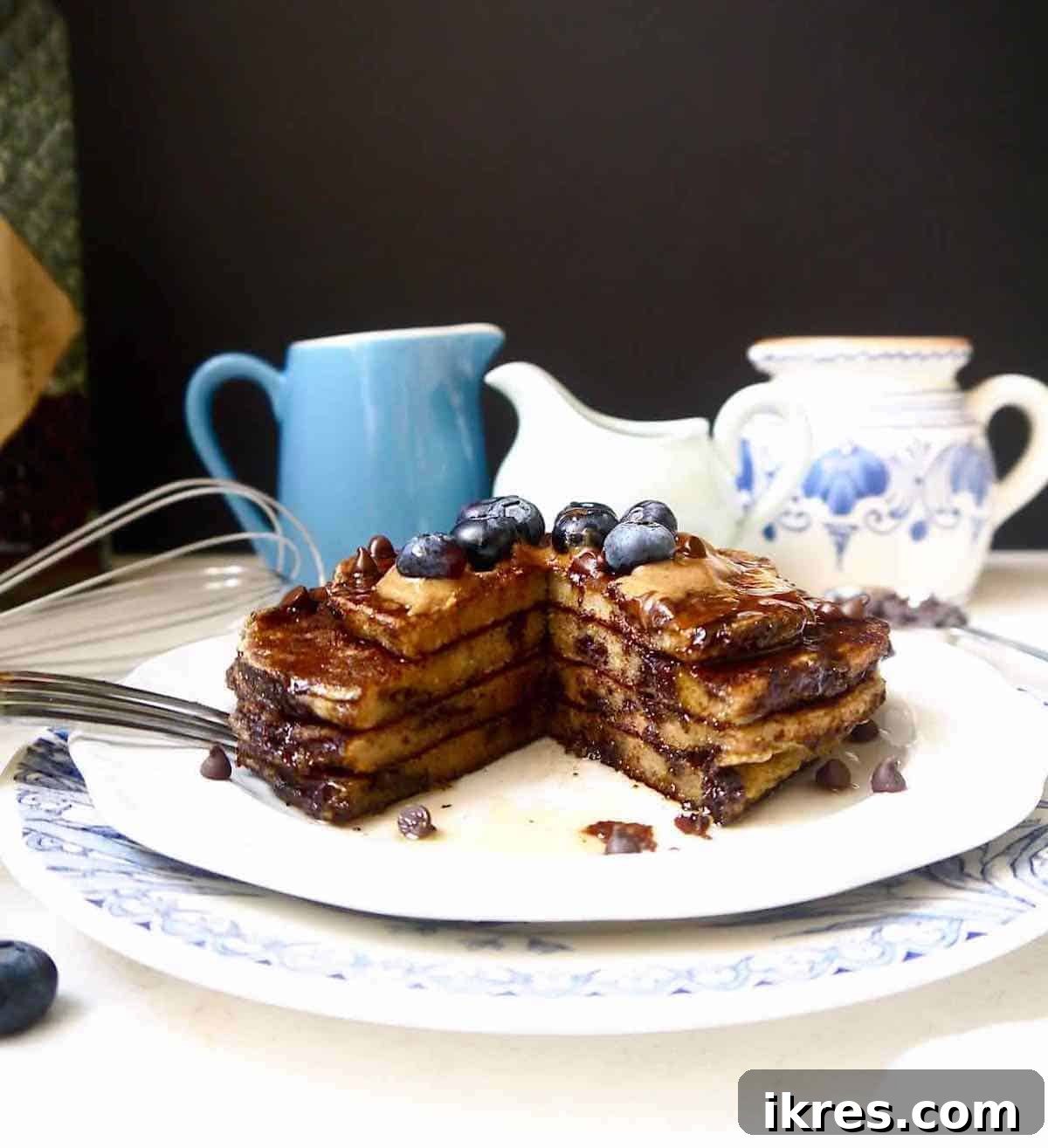 Dairy-free banana pancakes with a chunk cut out of it, showing the inside texture.