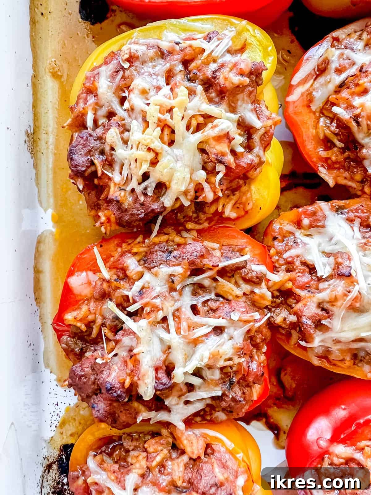 Freshly baked healthy stuffed peppers with ground beef and rice, served hot in a pan.