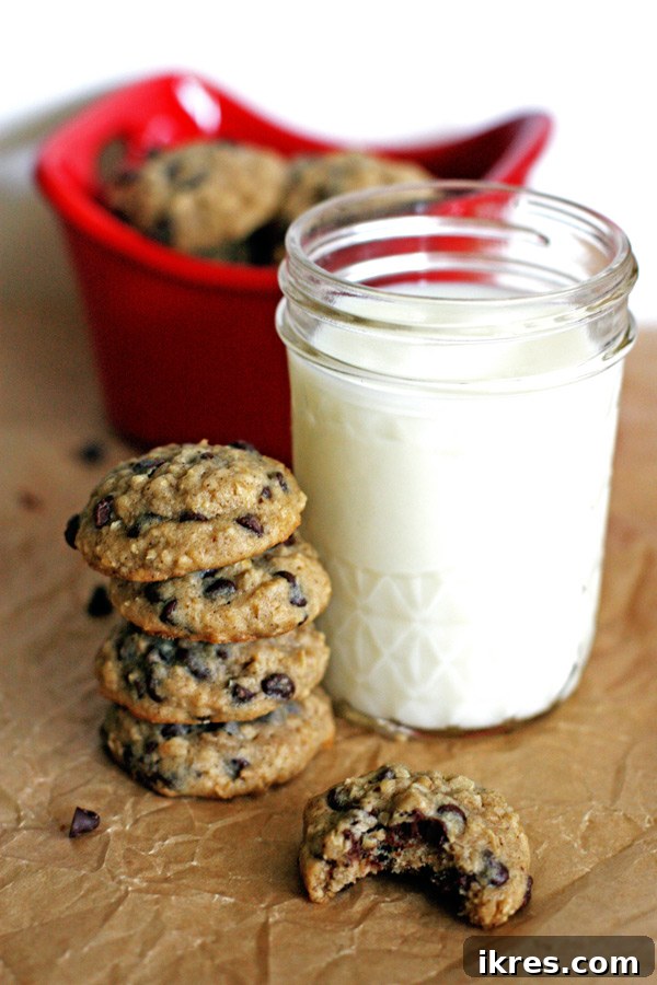 Freshly baked oatmeal chocolate chip cookies stacked on a white plate, ready to be served.