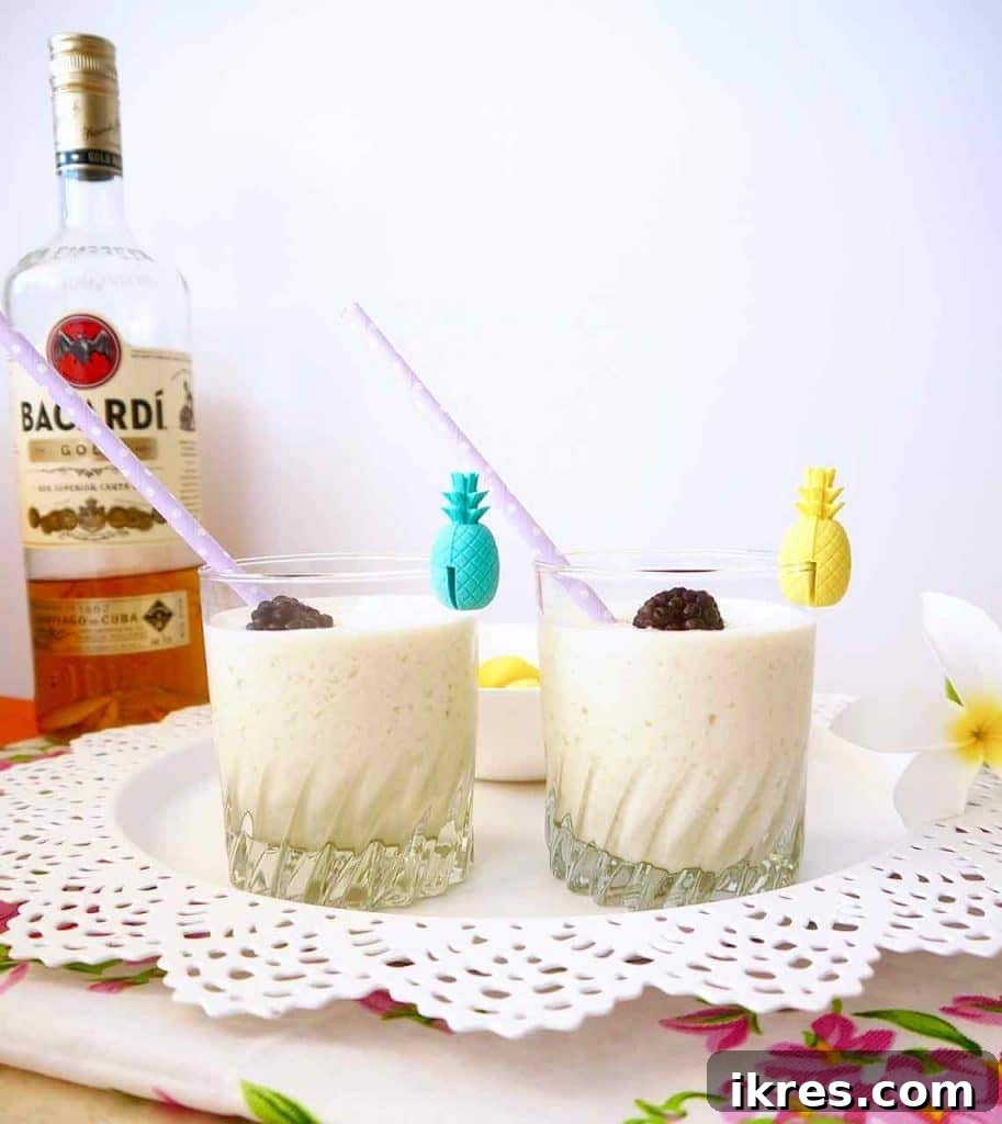 A refreshing glass of Piña Colada, perfectly blended and topped with a slice of pineapple.