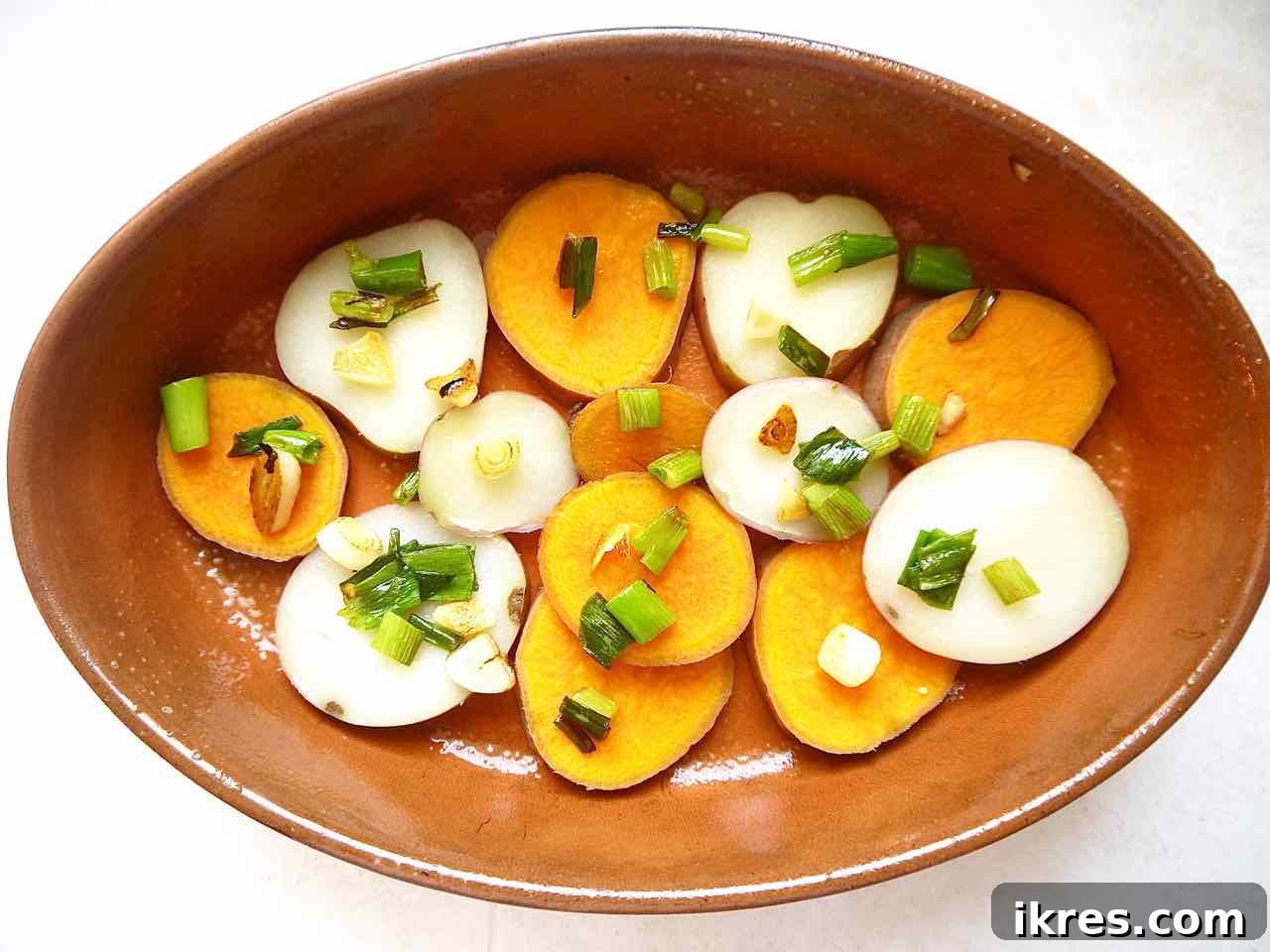 Layering potatoes and aromatics in a baking dish for the tortilla
