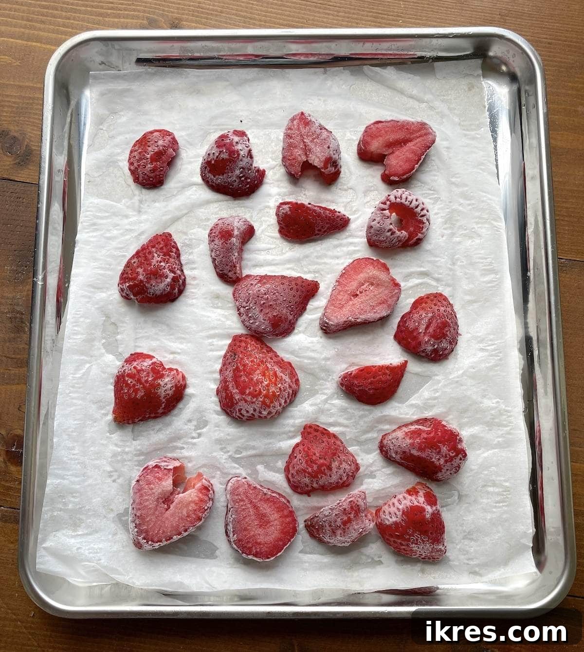 Thinly sliced strawberries ready to be frozen for jam and smoothies.