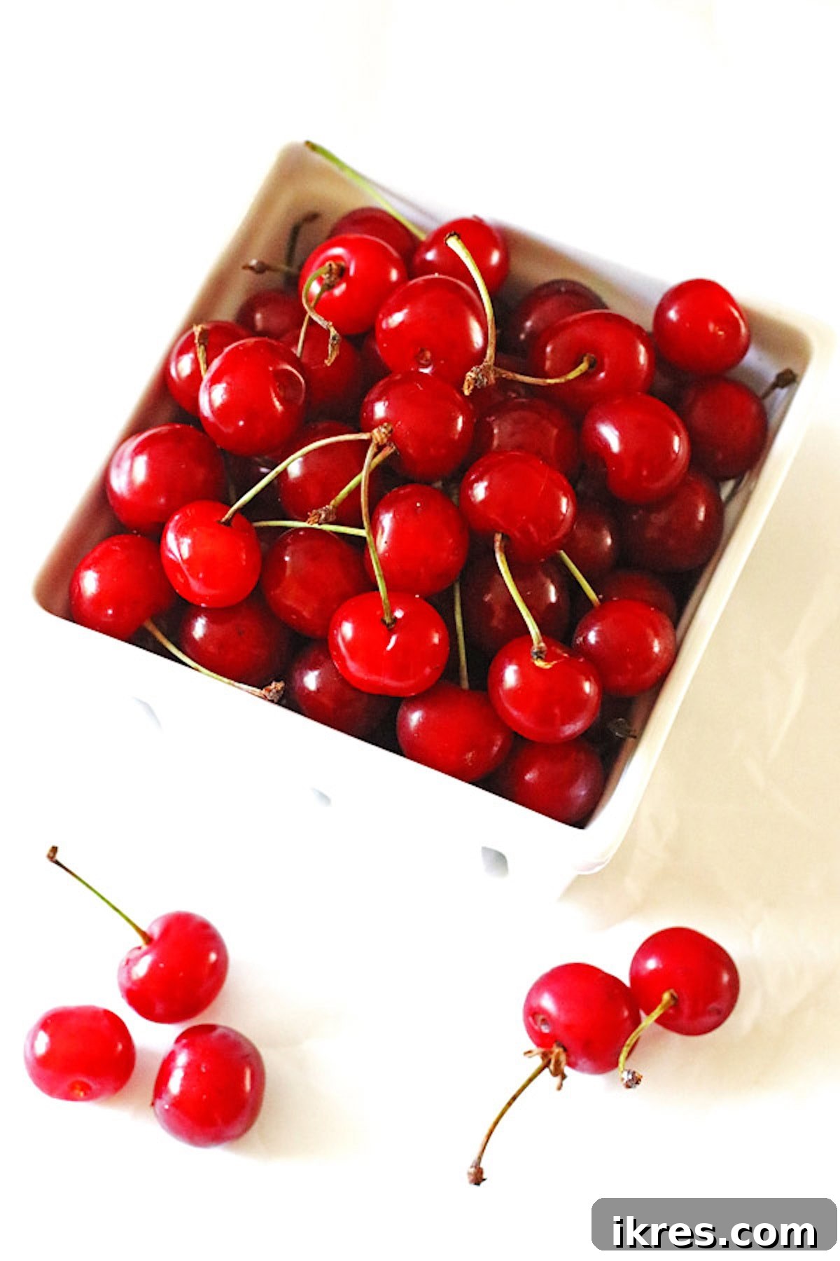 A ceramic dish of washed tart cherries.
