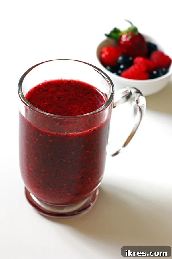 A tall glass of a refreshing Triple Berry Smoothie.
