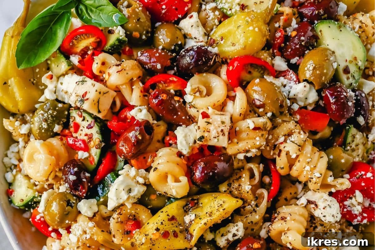 Homemade Greek Pasta Salad with olives, feta cheese, peppers, tomatoes, and cucumber