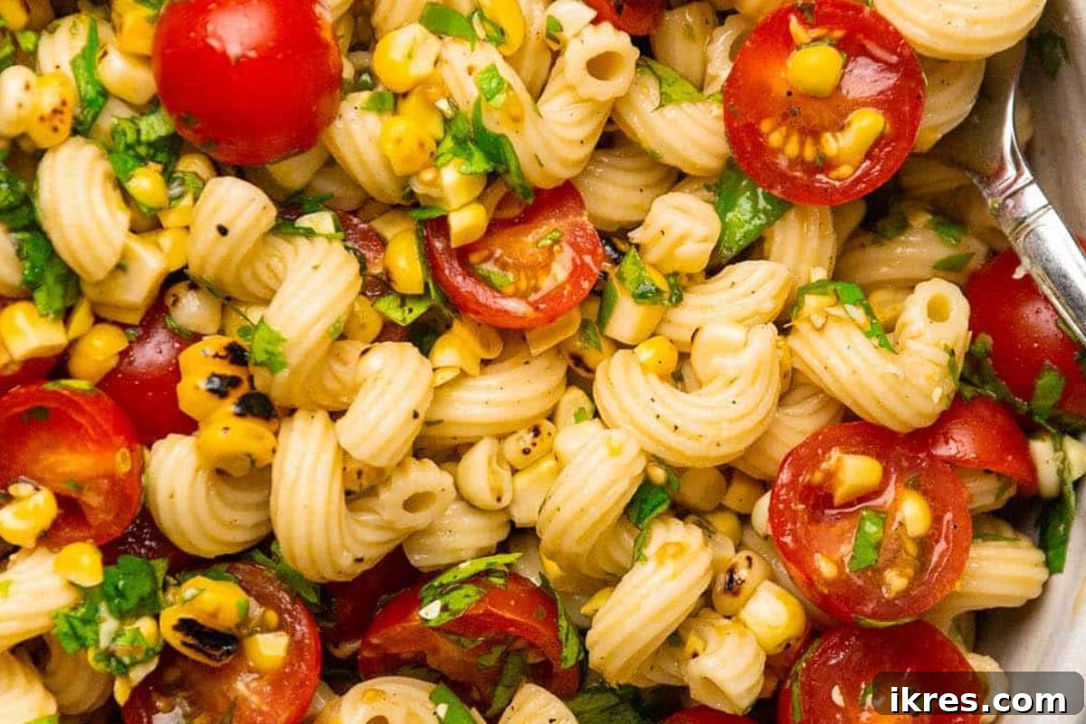 Pasta Salad with Corn and Tomatoes featuring cavatappi pasta and lemon dressing