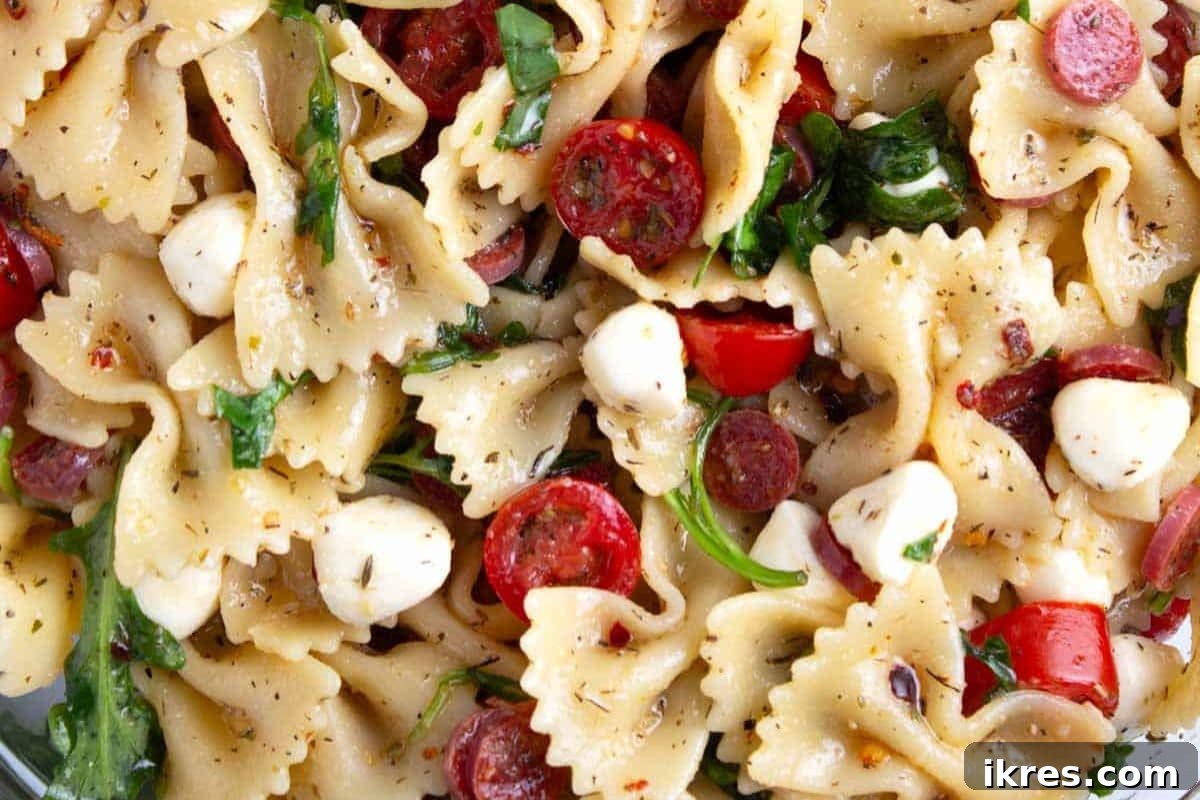 Hot Honey Pasta Salad with tender pasta, cherry tomatoes, mozzarella, and pepperoni