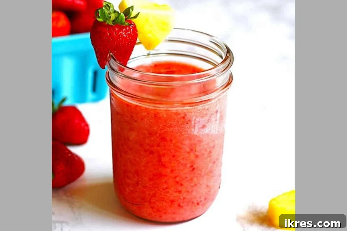 21 Afterschool Snack Hacks Kids Will Devour 14 Refreshing strawberry pineapple smoothie in a tall glass
