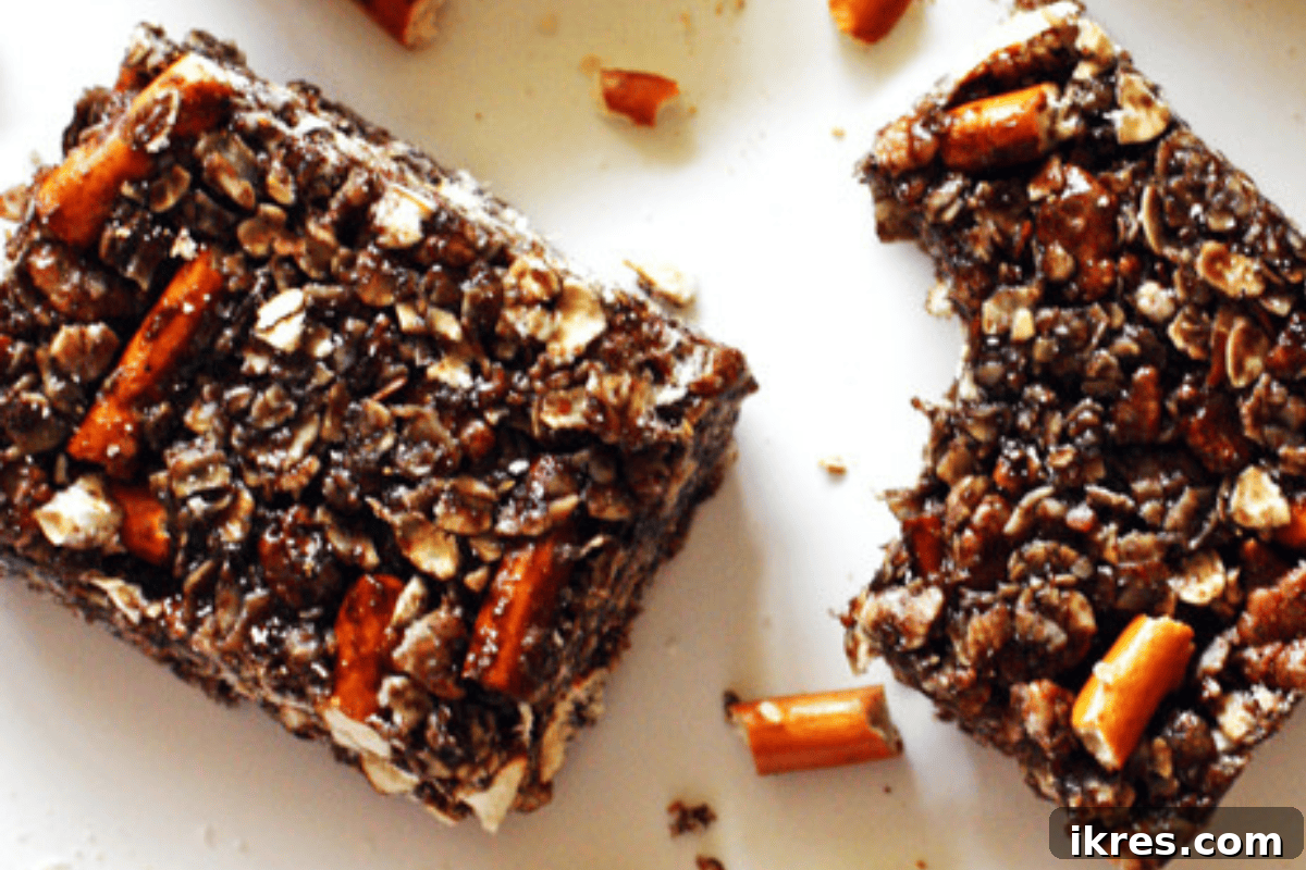 21 Afterschool Snack Hacks Kids Will Devour 3 Homemade dark chocolate pretzel granola bars stacked on a plate