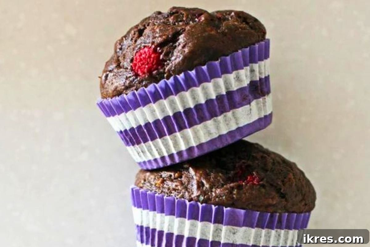 Rich dark chocolate raspberry banana muffins with a tender texture