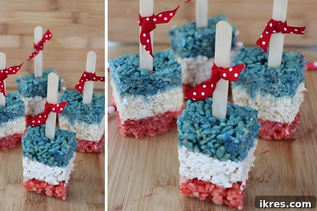 Red, White, and Blue Rice Krispie Treat Pops on sticks, perfectly sweet and gooey for patriotic holidays.