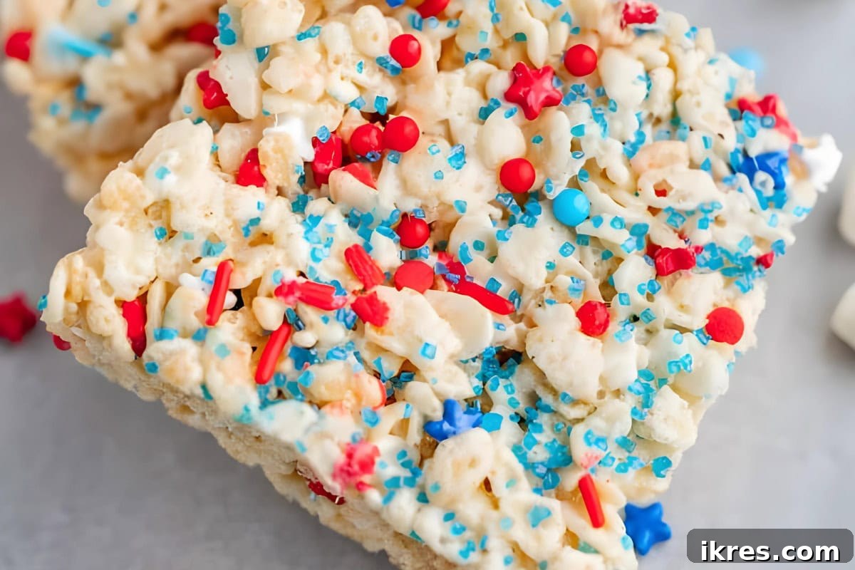 Festive Red White and Blue Rice Krispie Treats decorated with patriotic sprinkles, perfect for holiday celebrations.