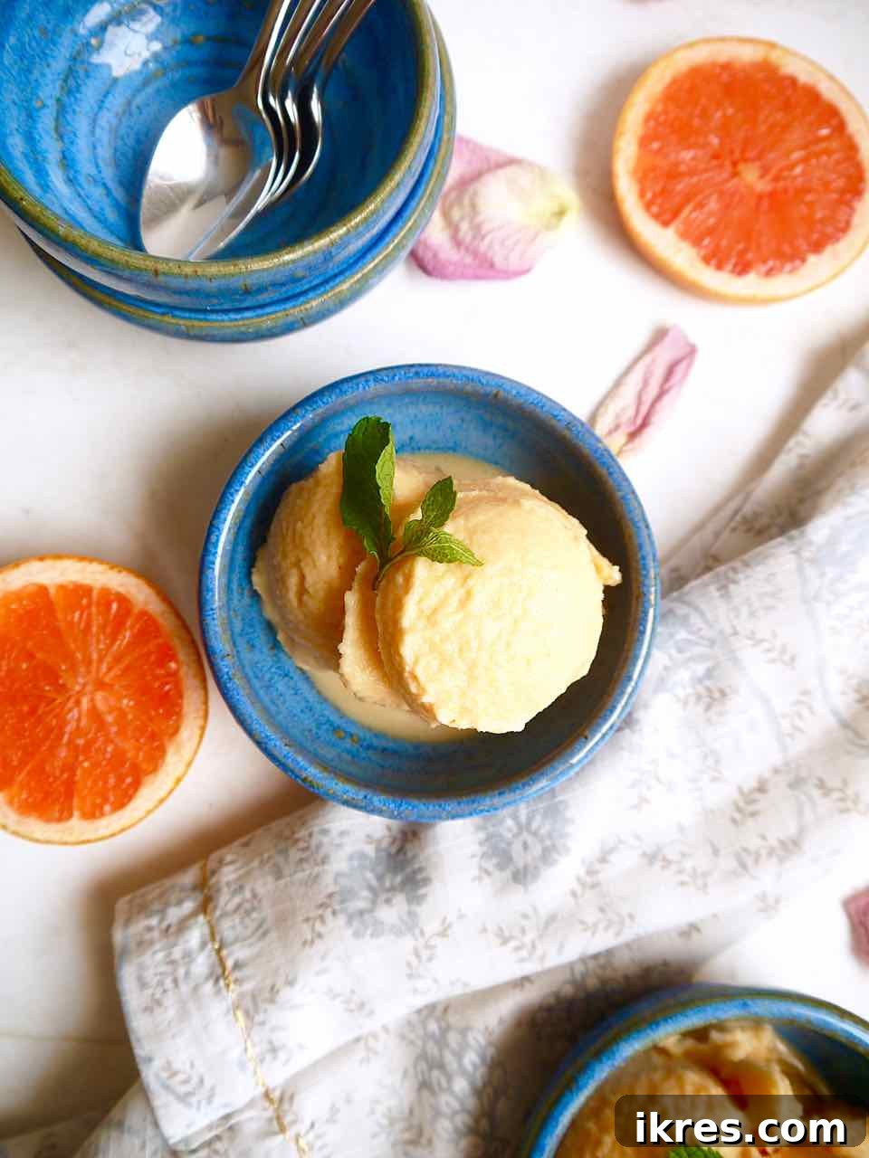 A close-up of creamy, dairy-free grapefruit sorbet in a white bowl.