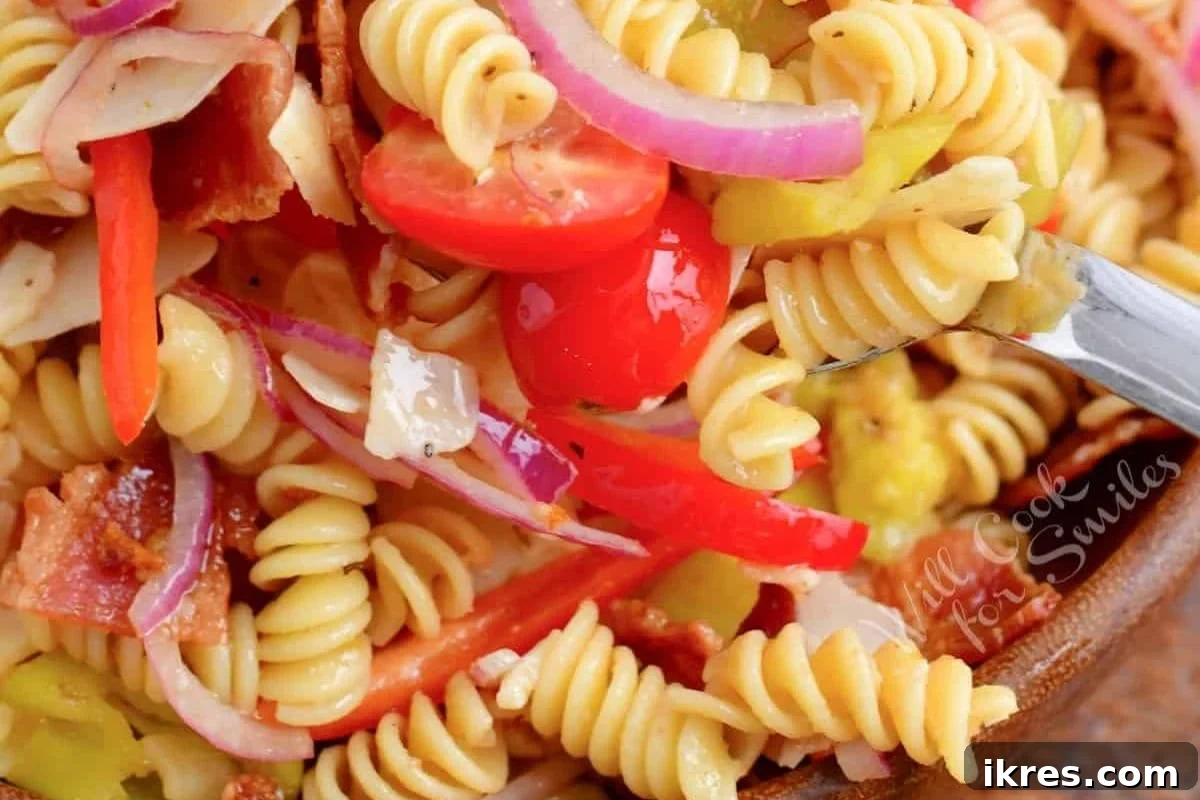 40 Irresistible BBQ Sides 2 A vibrant pasta salad with tri-color rotini, cherry tomatoes, cucumbers, and a creamy dressing.