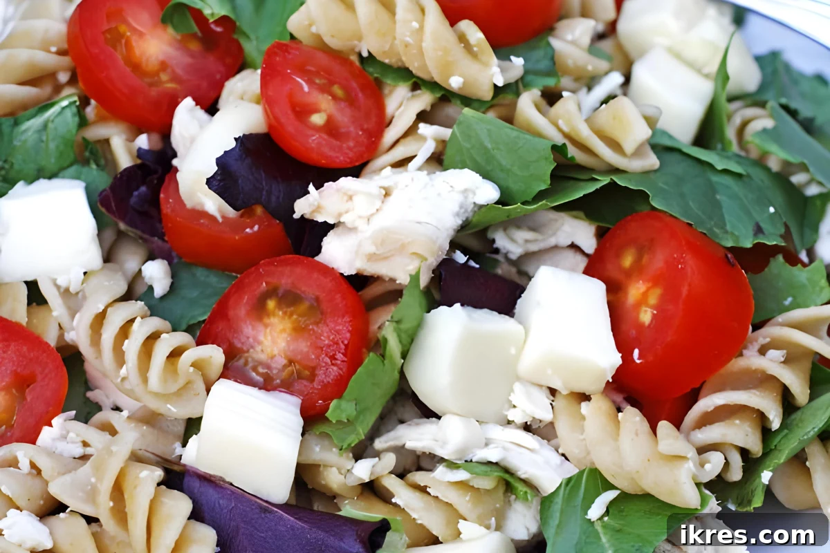 40 Irresistible BBQ Sides 11 A vibrant chicken garden pasta salad with rotini, shredded chicken, cherry tomatoes, cucumbers, and a creamy dressing.