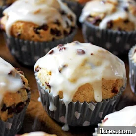 Delicious Banana Walnut Chocolate Chip Muffins generously covered in a sweet glaze.
