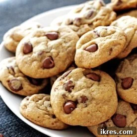 A plate of perfectly soft and chewy chocolate chip cookies, freshly baked and irresistible.