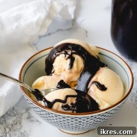 A decadent bowl of ice cream generously drizzled with rich, homemade hot fudge sauce.