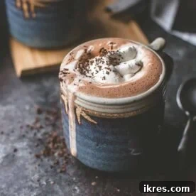 A steaming mug of homemade hot chocolate, rich and inviting, garnished with whipped cream or marshmallows.