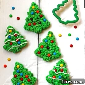 Charming green Rice Krispie Trees, festively decorated with colorful M&M candies and delicate white icing.