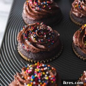 A perfectly frosted vegan chocolate cupcake, rich and indulgent, ready to be enjoyed.
