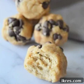 A selection of delicious No-Bake Energy Bites, with one showing a bite taken out, revealing its wholesome interior.