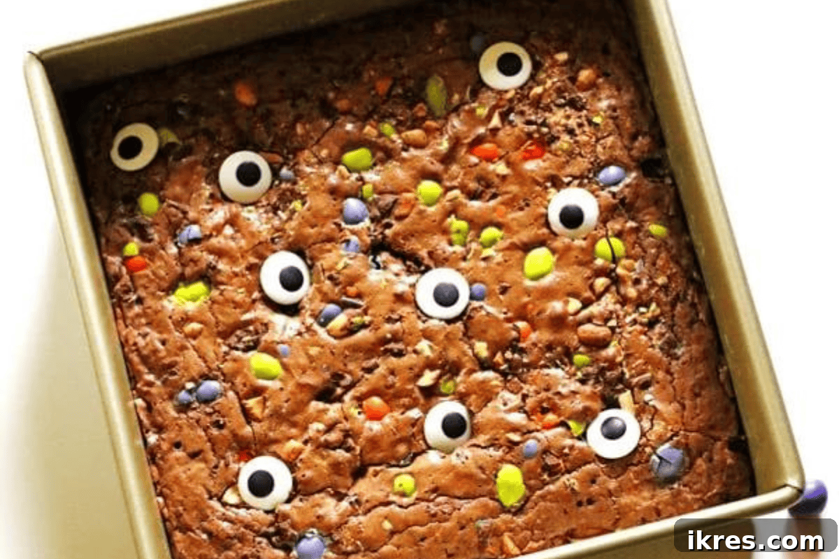 Rich Homemade Halloween Brownies decorated with edible candy eyes and festive M&M's