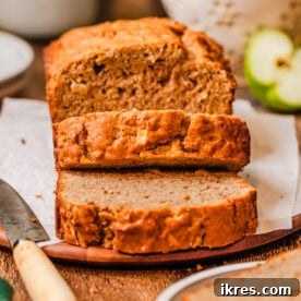 A slice of incredible apple bread, bursting with apples and aromatic spices.