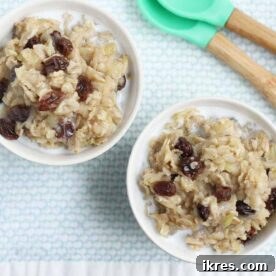 Two white bowls filled with easy apple cinnamon oatmeal with raisins.