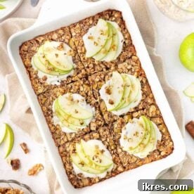 Baked apple cinnamon oatmeal topped with apple slices and spices.