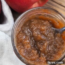 Homemade apple butter in a jar, ready to be enjoyed.