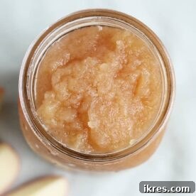 Easy crockpot applesauce stored in a mason jar.